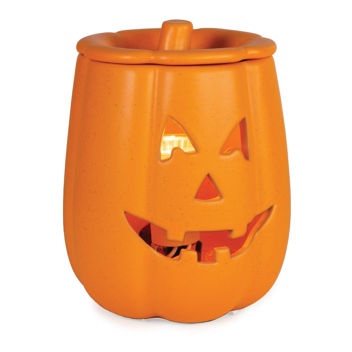 Orange ceramic Jack O’ Lantern Illumination Fragrance Warmer glowing with warm light