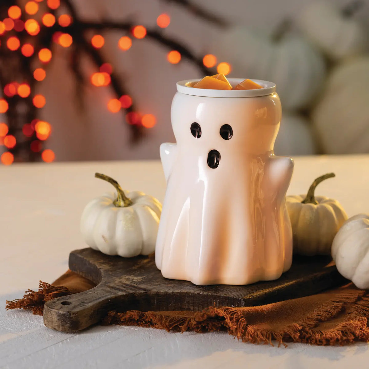 White ceramic Ghost Illumination Fragrance Warmer glowing with warm light